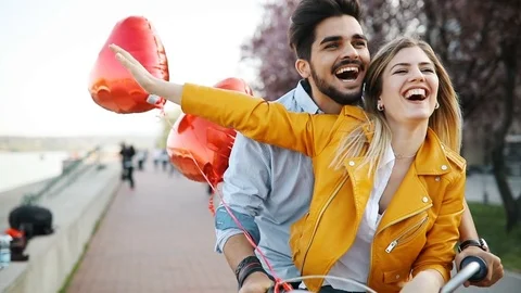 Young loving couple dating while riding bicycles in the city Stock Footage 78895870