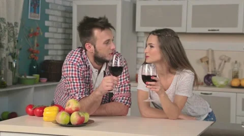 Young loving couple drinking wine in the kitchen Stock Footage 48834625