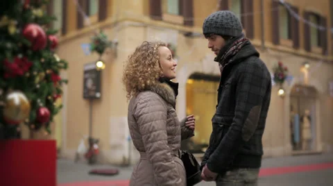 Young loving couple embracing each other in the street during Christmas period Stock Footage 33594963