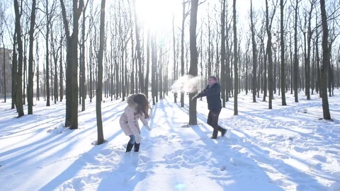 Young loving couple having fun in snowy park Stock Footage 81735685
