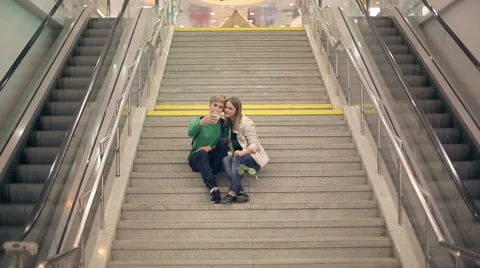 Young loving couple take selfie sitting on the steps of the college Stock Footage 42662053