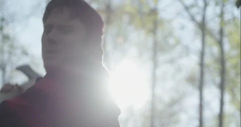 Young lumberjack chopping down tree Stock Footage 148177454