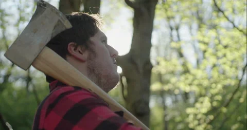 Young Lumberjack stares up at tree Stock Footage 148165765