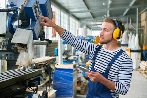 Young Machine Operator at Modern Plant Stock Photos