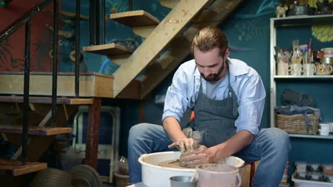 Young making a piece of clay molding calmly and meticulously Stock Footage 256866495