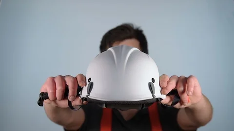 Young male apprentice construction worker wears hard hat, neutral background Stock Footage 104782159