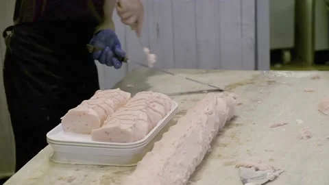 Young male apprentice works on cutting and setting fudge at bakery Video stock 161114301