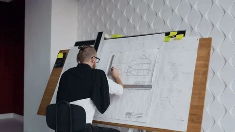 Young male architect working on drawing device a blueprint project of new Stock Footage 83030318