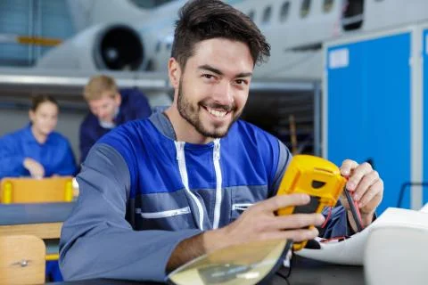 Young male aviation engineer using multi meter Stock Photos