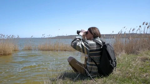 Young male with backpack and binoculars Stock Footage 90194271