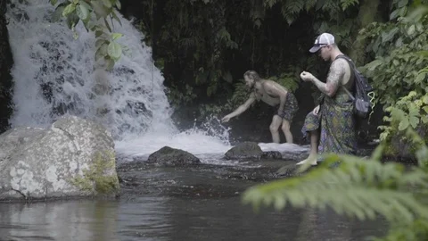 YOUNG MALE BACKPACKERS EXPLORING WATERFALL- TWO SHOT VARIATIONS- 1080P 23.98 Stock Footage 104155161