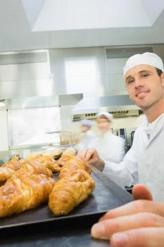 Young male baker standing in a bakery Stock Photos