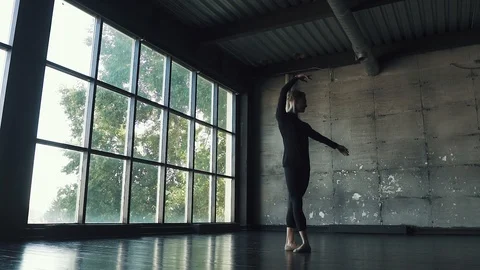 Young male ballet dancer dancing in studio on a dark background. slow motion Stock Footage 94135865