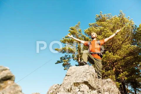 Young male with beard is traveling through the mountain, tourist rucksack Stock Photos