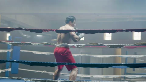 Young male boxer doing shadow fight while training Stock-Footage 181787357