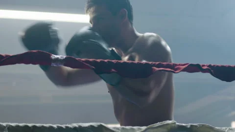 Young male boxer doing shadow fight while training Stock Footage 181789990