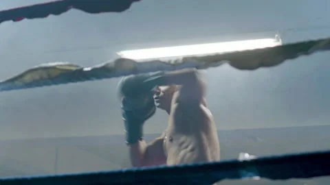Young male boxer doing shadow fight in boxing gym Video stock 181794824