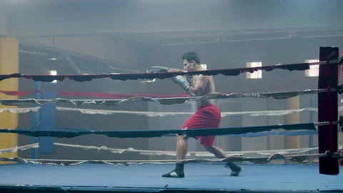 Young male boxer doing shadow fight while training Stock-Footage 181798224