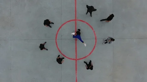 Young male breakdancer dancing with his friends around in circle. Drone vertical Stock Footage 98211882