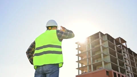 Young male builder engineer architect foreman in protective helmet stands with Видео 201364748