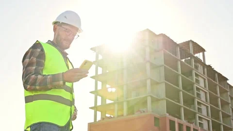 Young male builder engineer architect foreman designer typing on the phone Stockbeeldmateriaal 201364815
