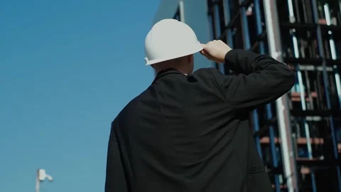 Young male builder engineer architect foreman in protective helmet stands with h Stock Footage 249263252