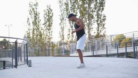 Young male busker dancer doing breakdance performance in city street Stock Footage 132070317