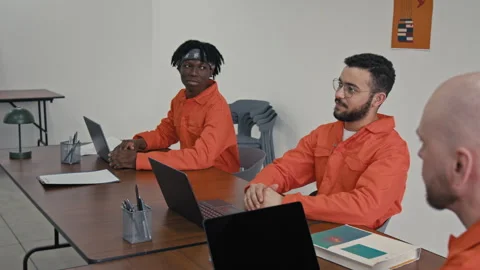 Young Male Convict Talking to Programming Teacher during Lesson in Prison Video stock 314055328