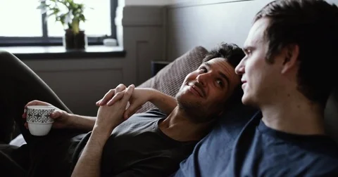 Young male couple relaxing with coffee Stock Footage