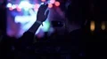 Young male dancing, waving hands and shooting video on cellphone at concert 4k or 4k+ Resolution