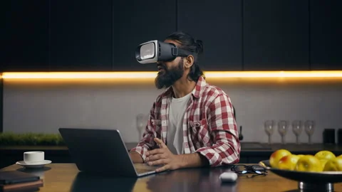 Young male developer troubleshooting VR game in headset, tracing coding errors Stock Footage 313281794