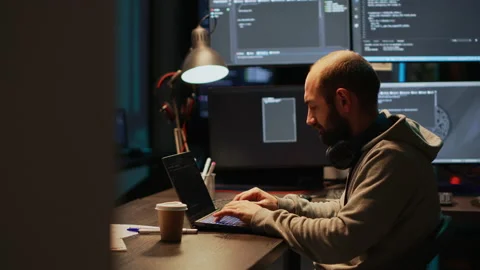 Young male developer typing server code on multiple screens Stock Footage 224578167