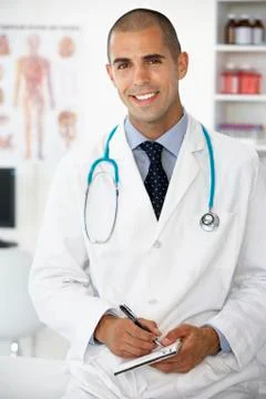 Young male doctor writing prescription Stock Photos