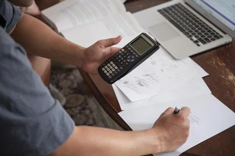 Young male doing math schoolwork at home Stock Photos
