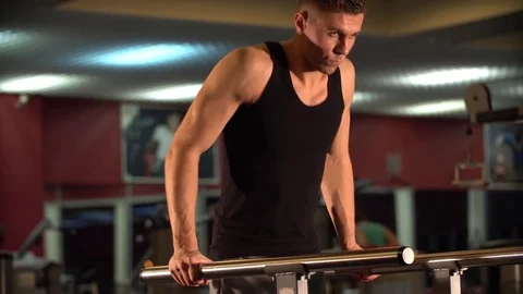 Young male doing tricep dips in a gym Video stock 72499174