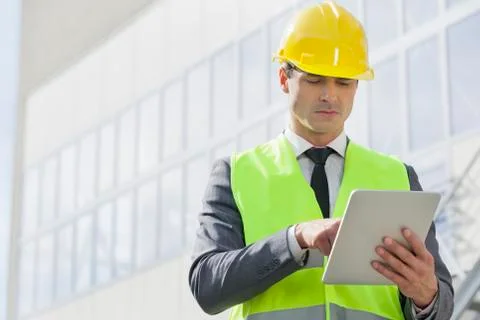 Young male engineer using digital tablet outside industry Stock Photos