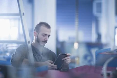 Young male engineer using a digital tablet in an industrial plant, Freiburg im B Stock Photos