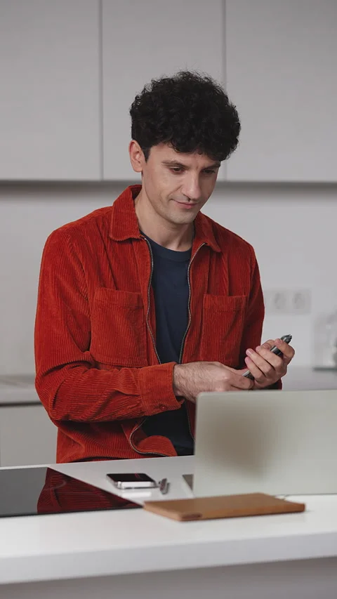 Young male freelancer counting dollars in front of laptop, pleased with profit Stock Footage 341017675