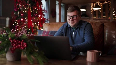 Young Male Freelancer Smiling While Working on a Laptop and Taking a Break Stock Footage 347694294