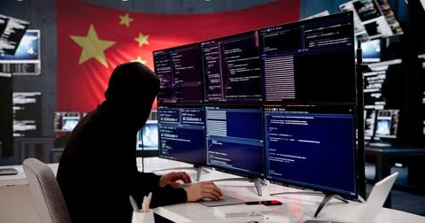 Young Male Hacker Coding Against A Backdrop Of The Chinese National Flag Stock-Fotos