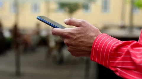 Young male hand using smartphone mobile outside. Business lifestyle. Online web Video stock 133398431