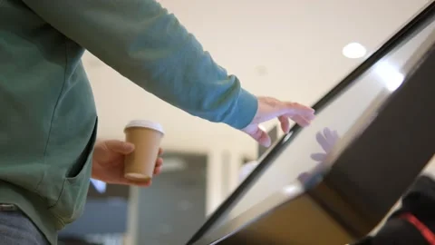 Young male hands dressed in jacket swiping for information in kiosk on Stock Footage 240477438