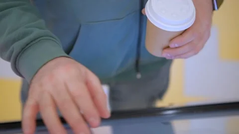 Young male hands dressed in jacket swiping for information in kiosk on Stock Footage 240973852