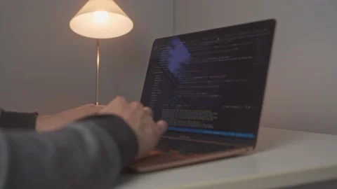 Young male hands work to code up a new website. A long tedious day for a Stock Footage 213123648