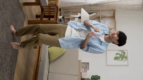 Young male having fun dancing to the songs Stock Footage 219398601