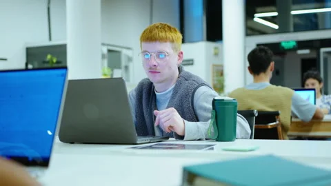 Young Male Office Worker Using Laptop at Desk Stock-Footage 243956939