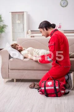 Young male paramedic visiting young woman Stock Photos