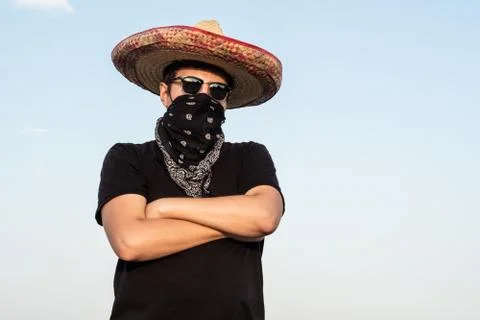 Young male person dressed up as gangster in traditional sombrero, bandana. Stock Photos