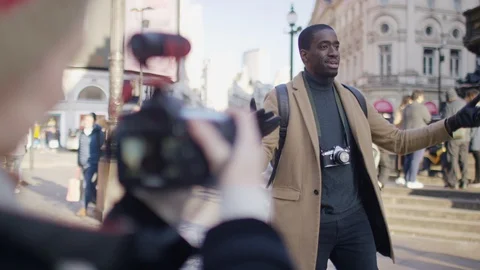 Young male presenter talking to camera addressing his followers as he stands in Stock Footage 122247233