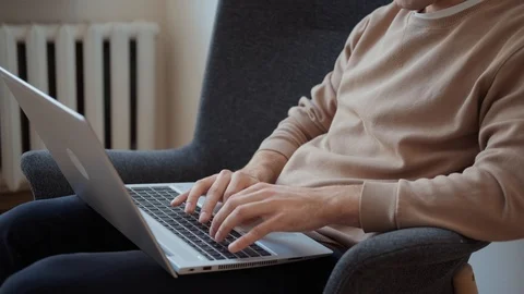 Young male professional using computer sitting at home. Stock-Footage 127346053